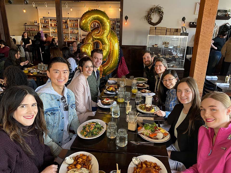 Residents gathered around a dining table to celebrate several birthdays