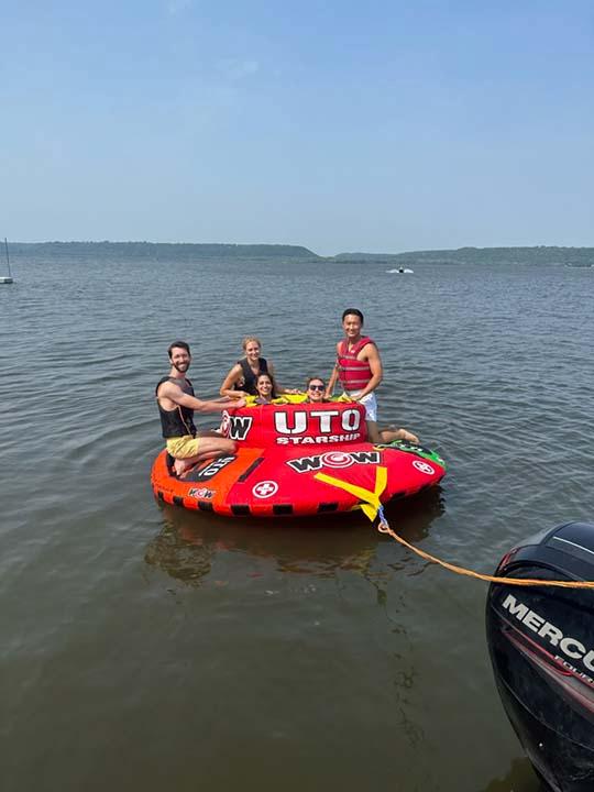Several residents enjoy their day by riding a tube on a local lake during the annual resident retreat.