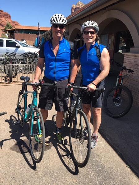 Two faculty members stop to take pictures after a long bike ride.