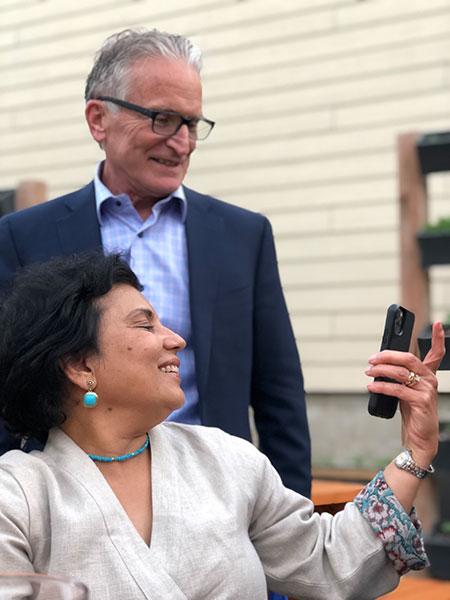 Two faculty members look at a photo together.