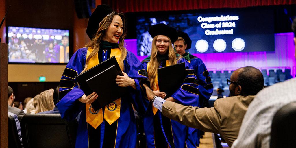 Graduates walk down the aisle during the 2024 Mayo Clinic Commencement ceremonies in Minnesota.