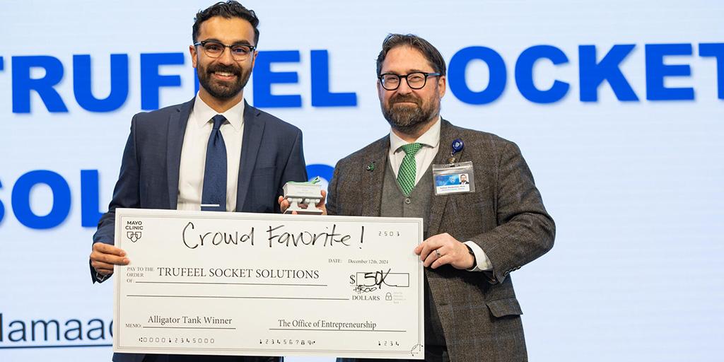 Hamaad Khan, DO, Preliminary Internal Medicine resident, is presented as the $5500 winner during Alligator Tank, a healthcare innovation pitch competition sponsored by the Office of Entrepreneurship.
