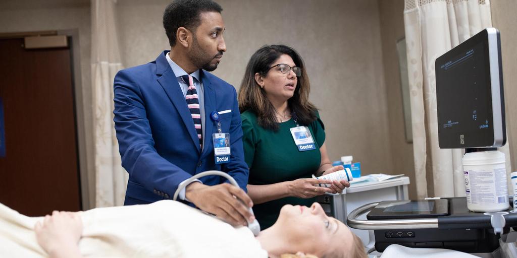 A Mayo Clinic endocrinologist operated an ultrasound machine to examin a patient's thyroid