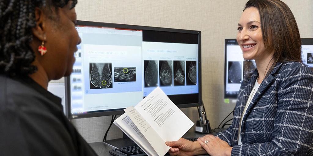 Dr. Kristin Robinson (right) speaks with a patient