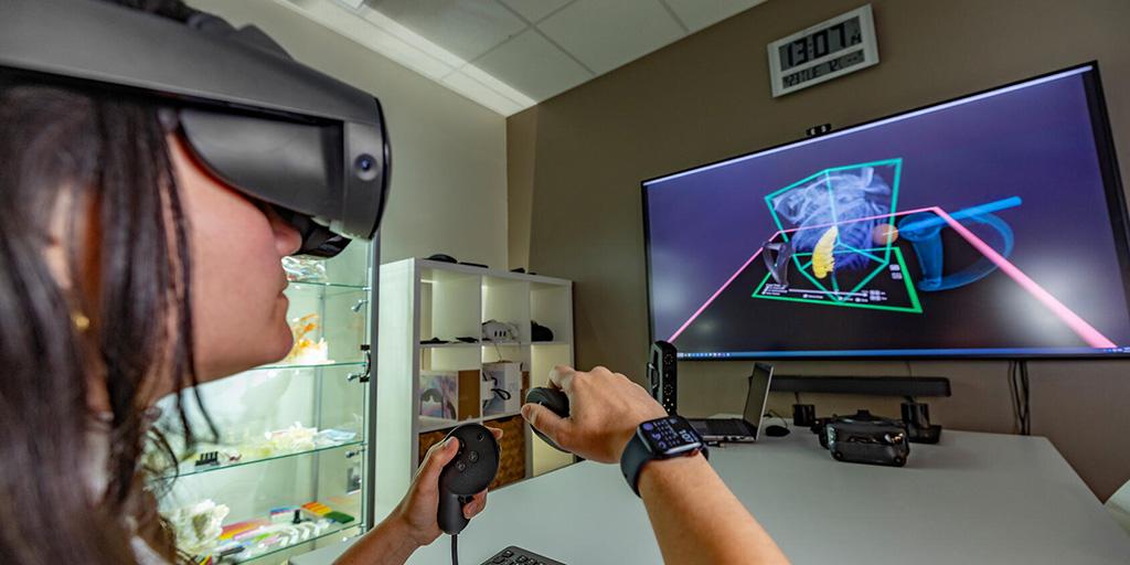 Carleigh Eagle, 3-dimensional (3-D) lab engineer, using a virtual reality (VR) headset.