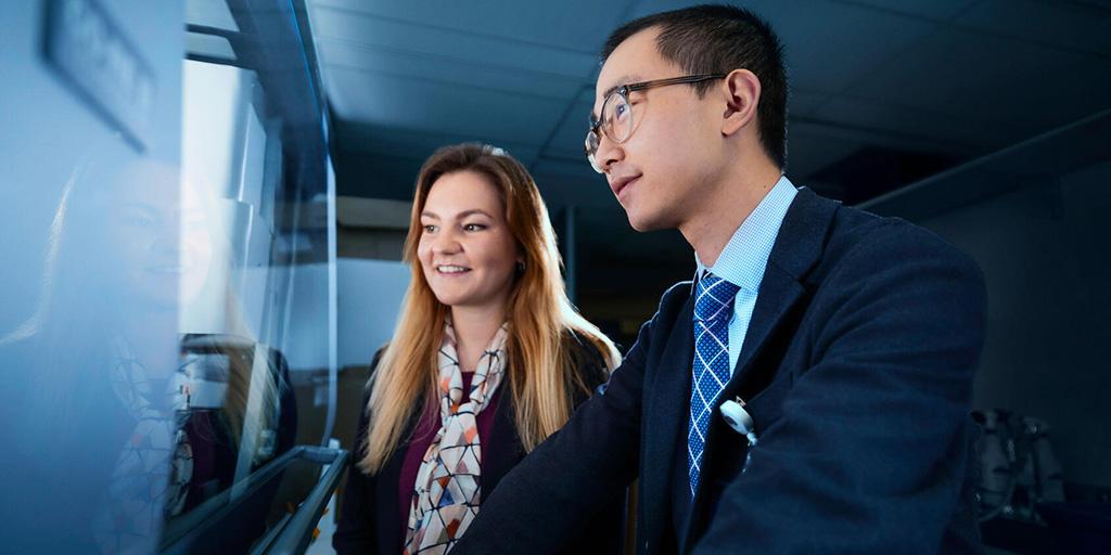 Harry Min, PhD, and Stephanie Oatman, PhD, Research Fellows, collaborating in the research lab