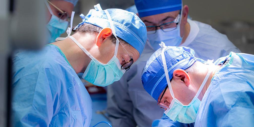 Transplant surgeon works with a fellow in the operating room at Mayo Clinic