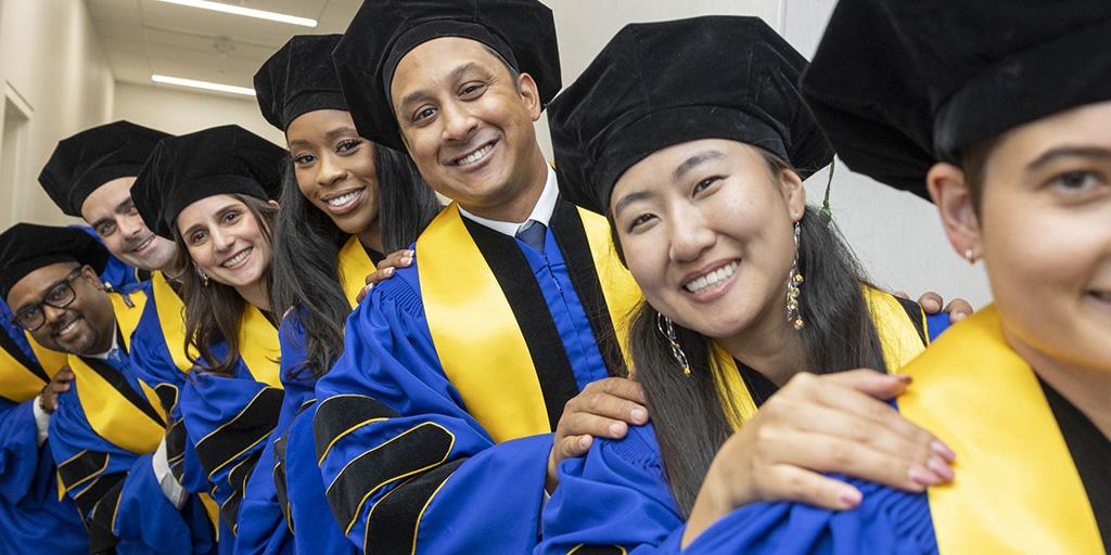 Mayo Clinic graduates line up and smile for a photo at 2026 Commencement in Florida