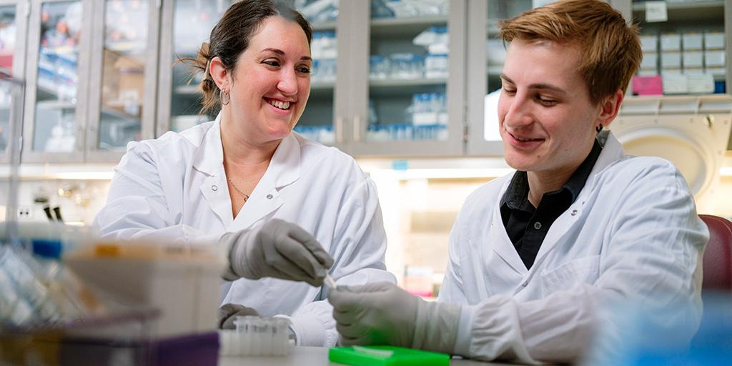 A Mayo Clinic instructor and learner work with materials in the lab
