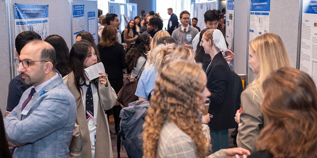 Attendees gather and view poster presentations during the 2026 Mayo Clinic Graduate School of Biomedical Sciences (MCGSBS) Student Research Symposium.