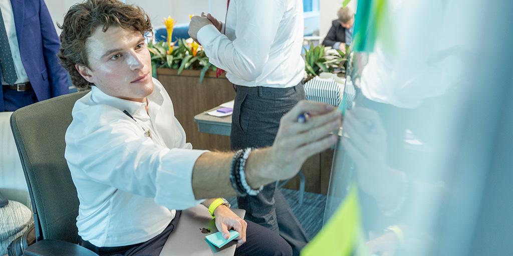 Guy Robinson, M.B.B.S., an internal medicine resident, works on a project at an innovation summit at Mayo Clinic