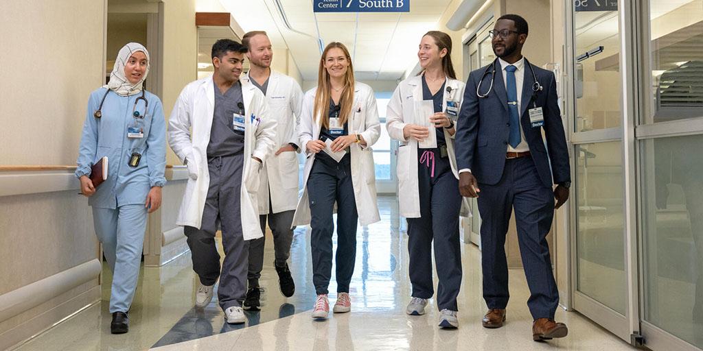 A group of internal medicine residents and fellows walk down the hallway at Mayo Clinic