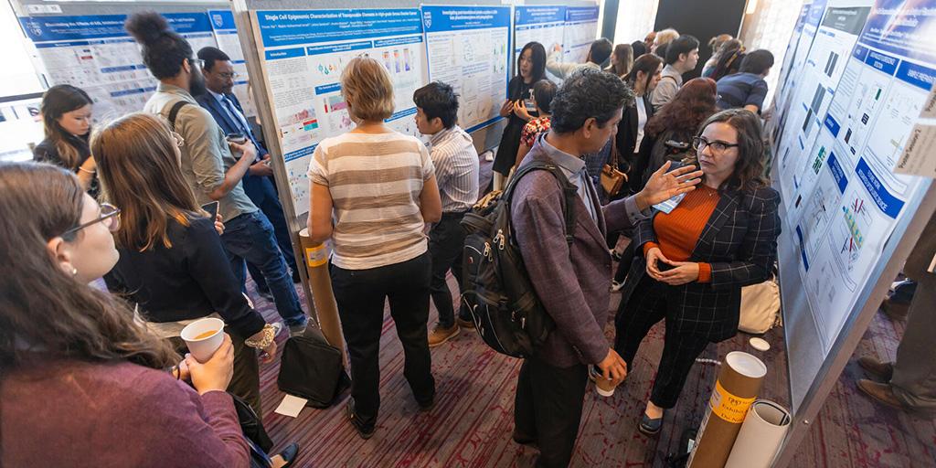 Students, faculty, and researchers mingle and view research posters at the 2024 Research Symposium by Mayo Clinic Graduate School of Biomedical Sciences