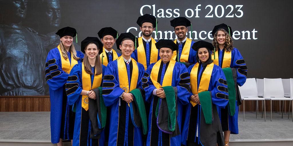 Group photo of nine medical students at Commencement 2023 from Mayo Clinic Alix School of Medicine in Florida