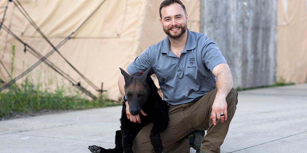 Jessie Milaski, Military Medicine Program instructor, poses with a K9 simulation manikin during a trauma care training.