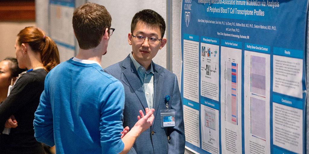 Mayo Clinic Ph.D. Program students talking at a scientific poster session