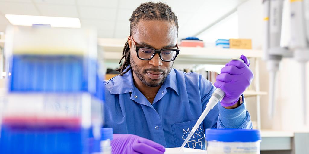 A researcher using a pipette in a lab