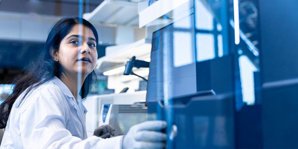 A research fellow works with a microbiology testing and identification system
