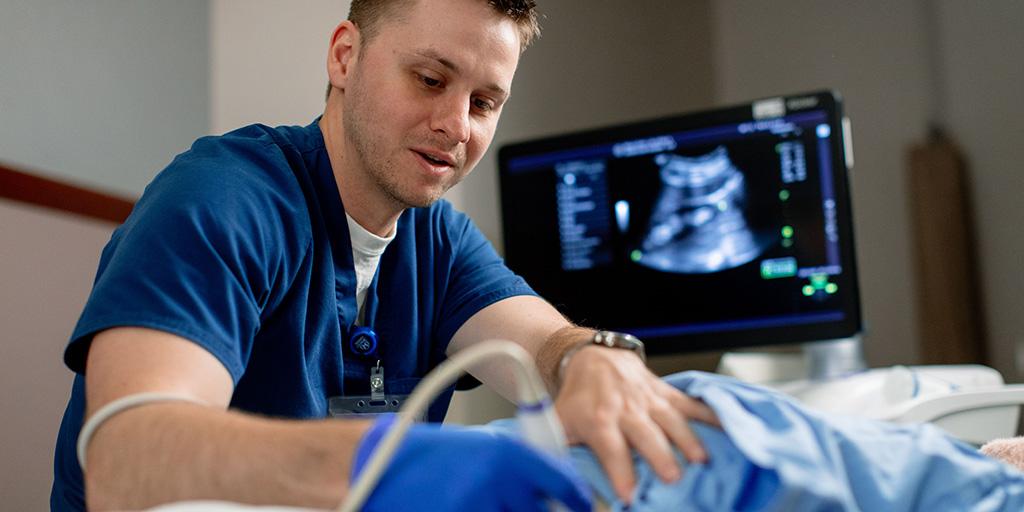 A person using a machine to help a patient.