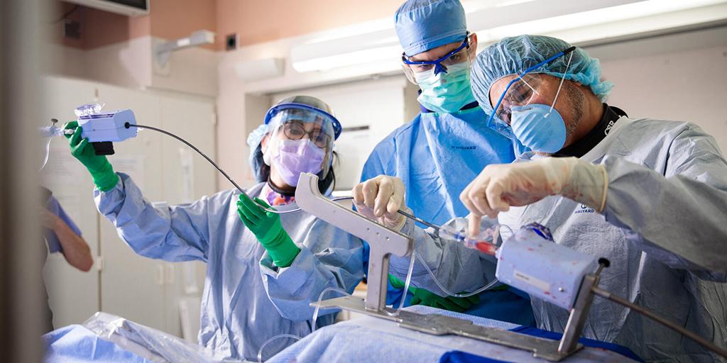 Surgeons guiding a catheter during cardiac catheterization on a patient. Photos requested to show live shots during a cardiac catheterization for a presentation booth at the Transcatheter Cardiovascular Therapeutics conference.