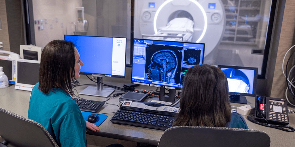 Two students monitoring scanning equipment