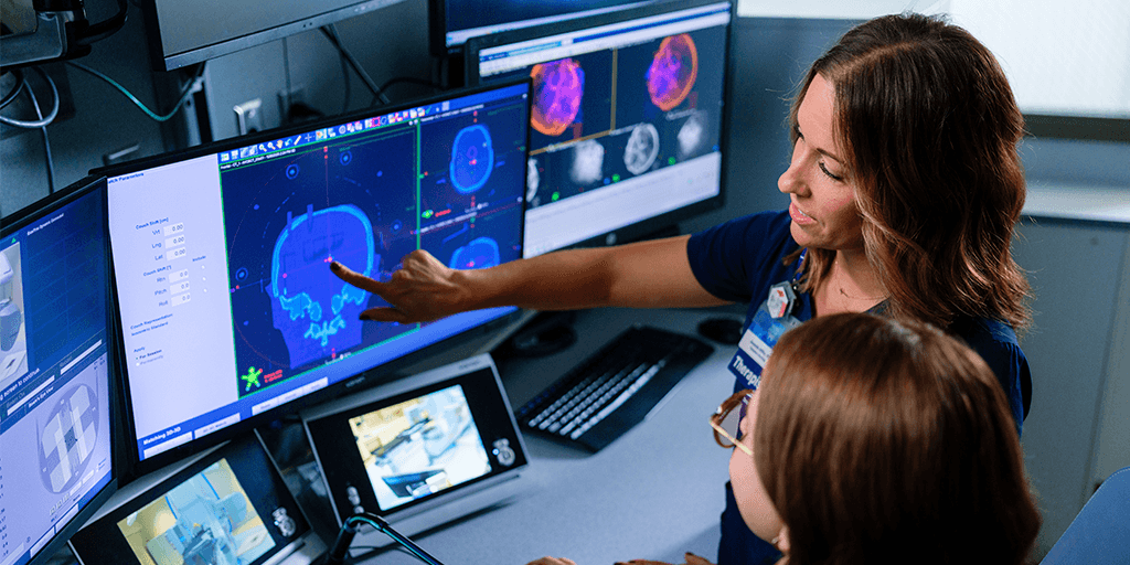 Radiation therapists looking at a scan