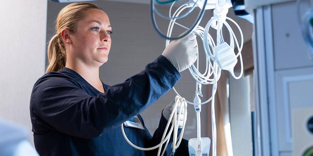 A Registered Nurse checks a patient's blood pressure in the ICU at Mayo Clinic