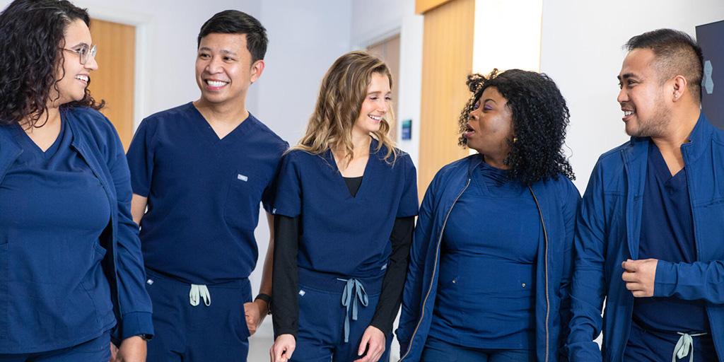A group picture of several Mayo Clinic nurses in blue scrubs
