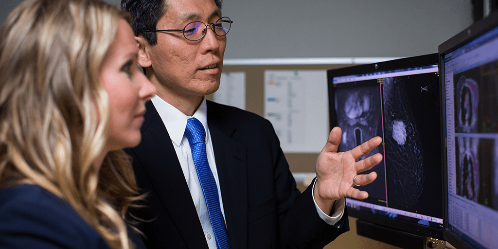 Two people looking at computer images