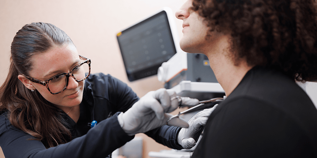 Speech language pathology fellow performing test on a patient