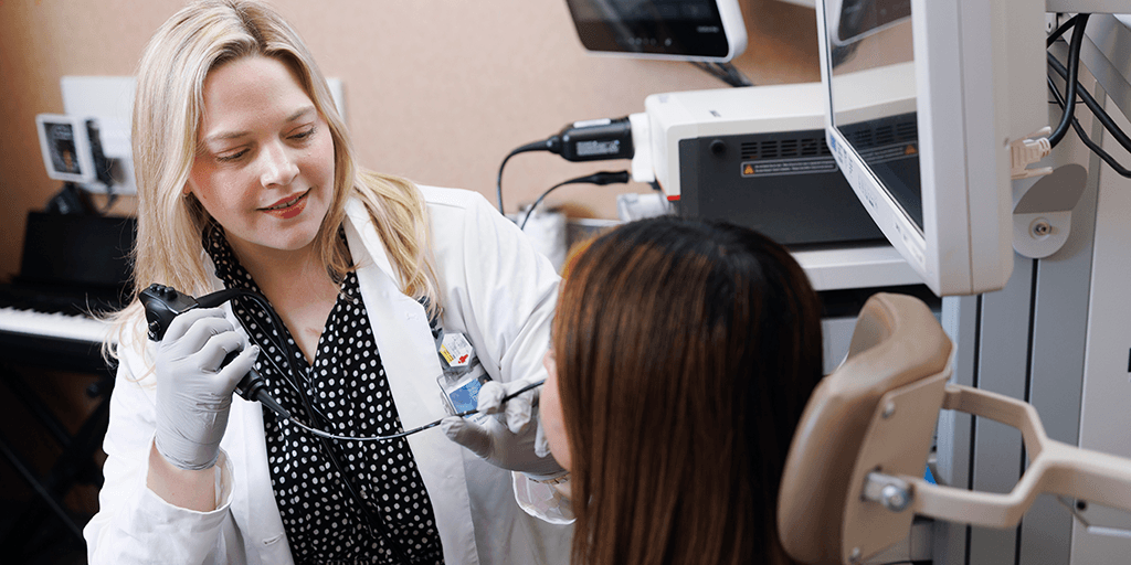 A Speech Language Pathologist performing scan on patient