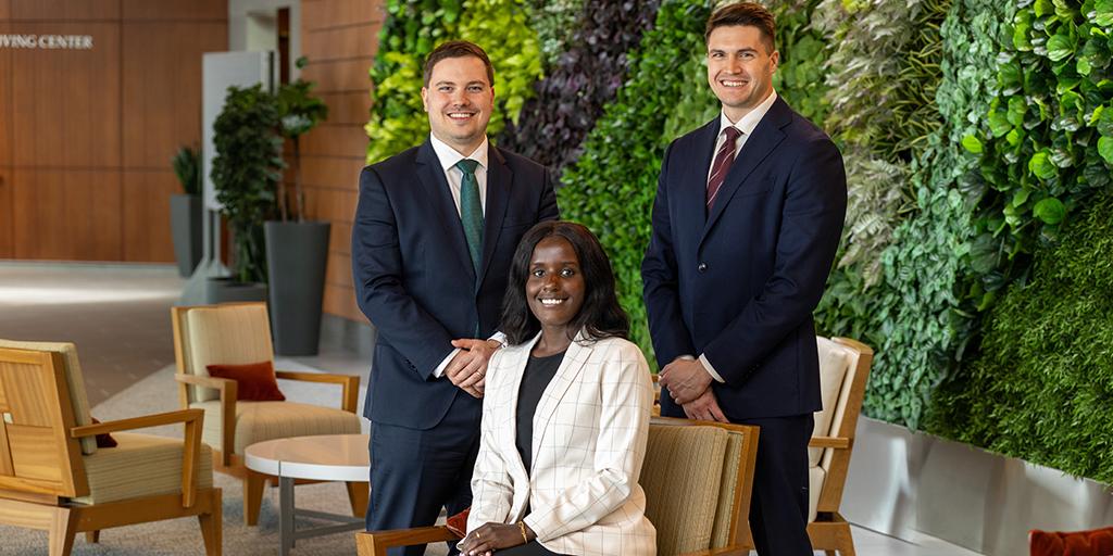 Three fellows pose for a group photo.