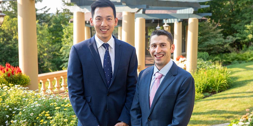 Two alumni of a Mayo Clinic fellowship in Minnesota pose in a group picture