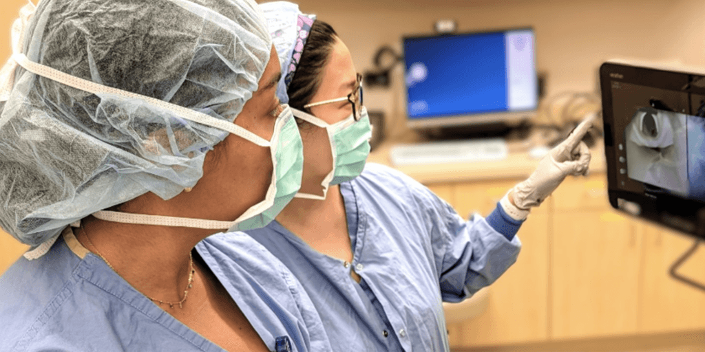 Dr. Harbell and a resident look at a screen