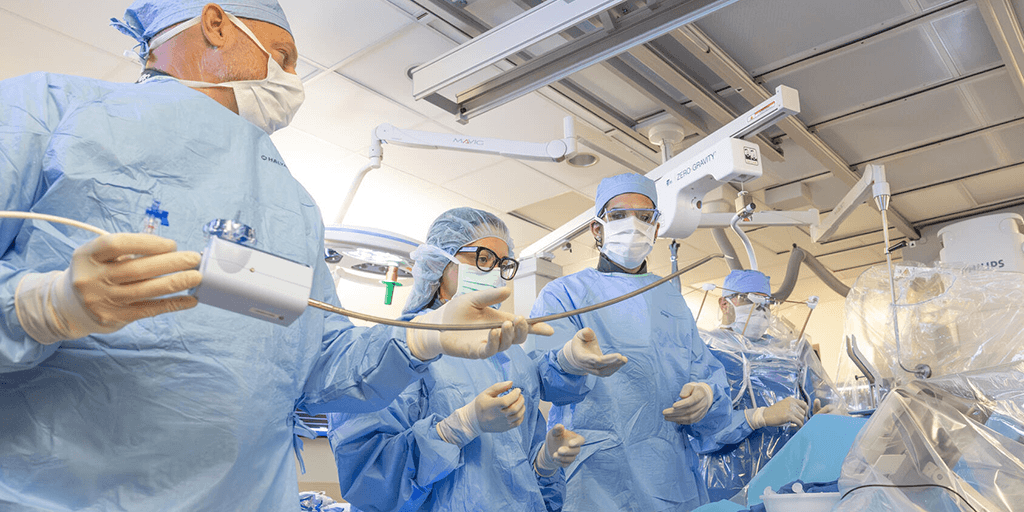 Interventional cardiologists performing a procedure in the catheterization (cath) lab.