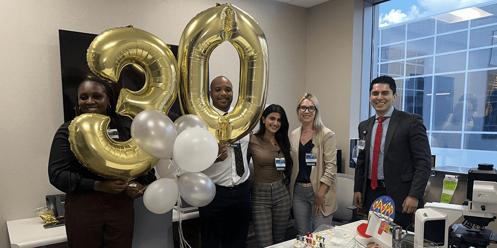 Residents celebrate a 30th birthday with balloons and treats.