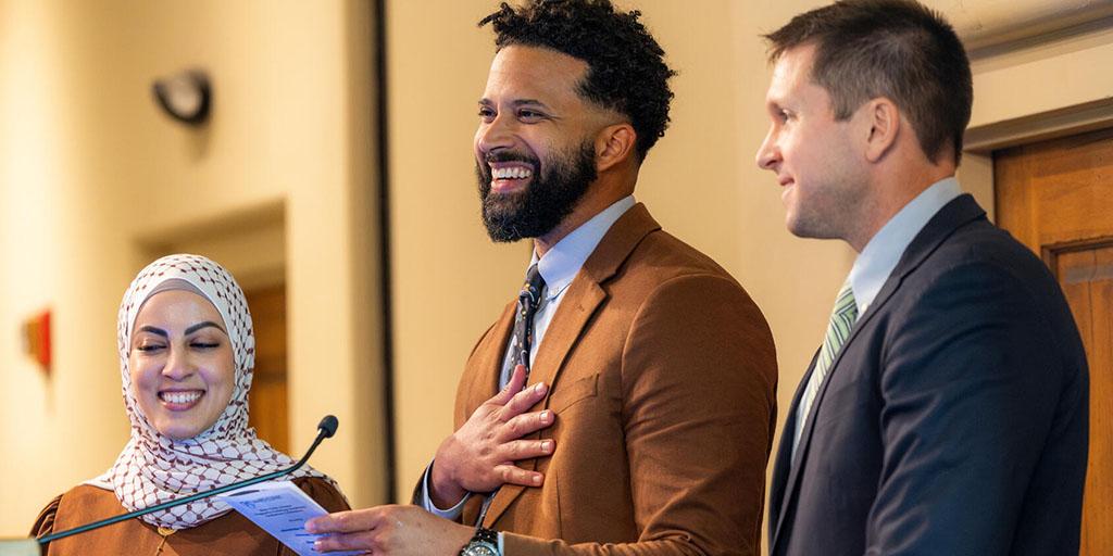 Three graduating diagnostic radiology residents deliver remarks together during the residency graduation celebration event.