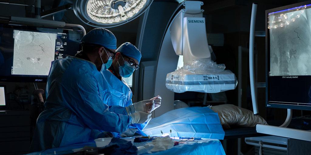 Two radiology residents perform a image guided procedure