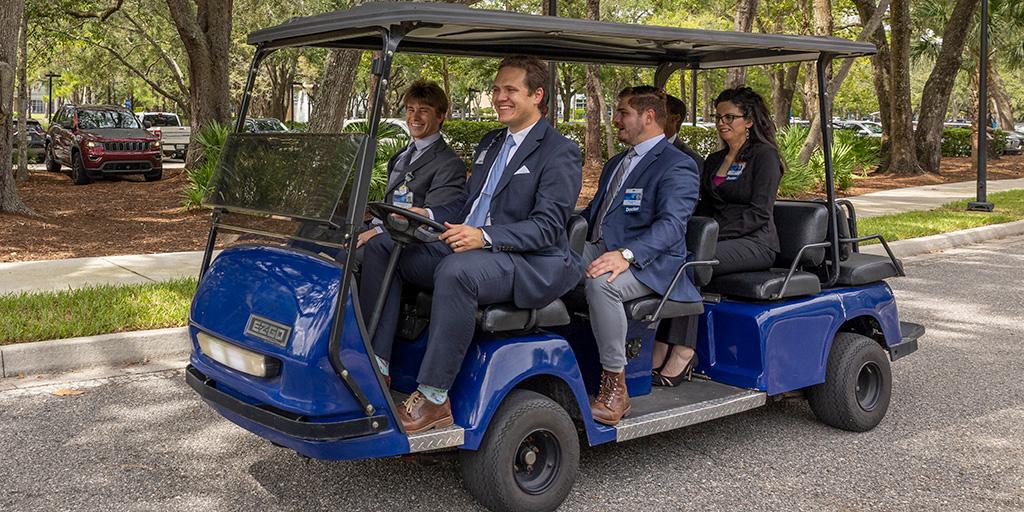 Diagnostic Radiology residents ride together on a golf cart on the Jacksonville campus.