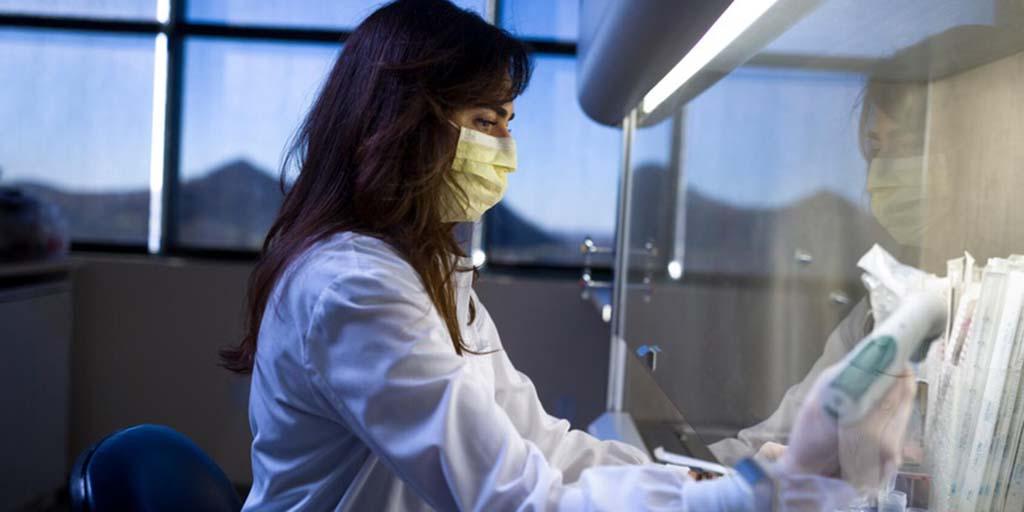 A doctor looks at medical equipment.