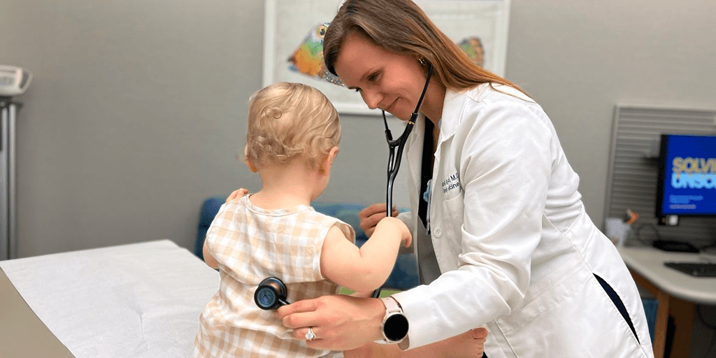 A doctor examining a young patient with a stethoscope