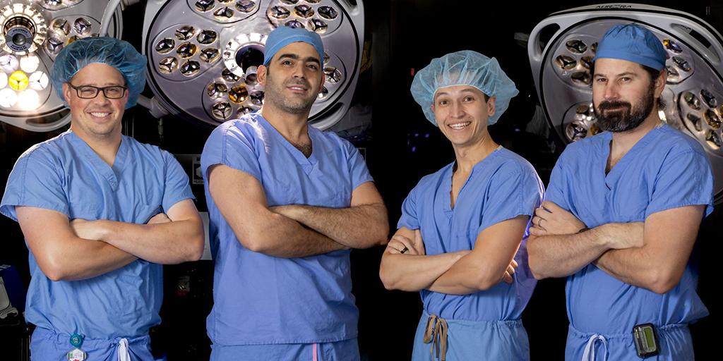 Four doctors from the General Surgery Residency program at Mayo Clinic in Phoenix, Arizona posed for a group photo in an operating room.