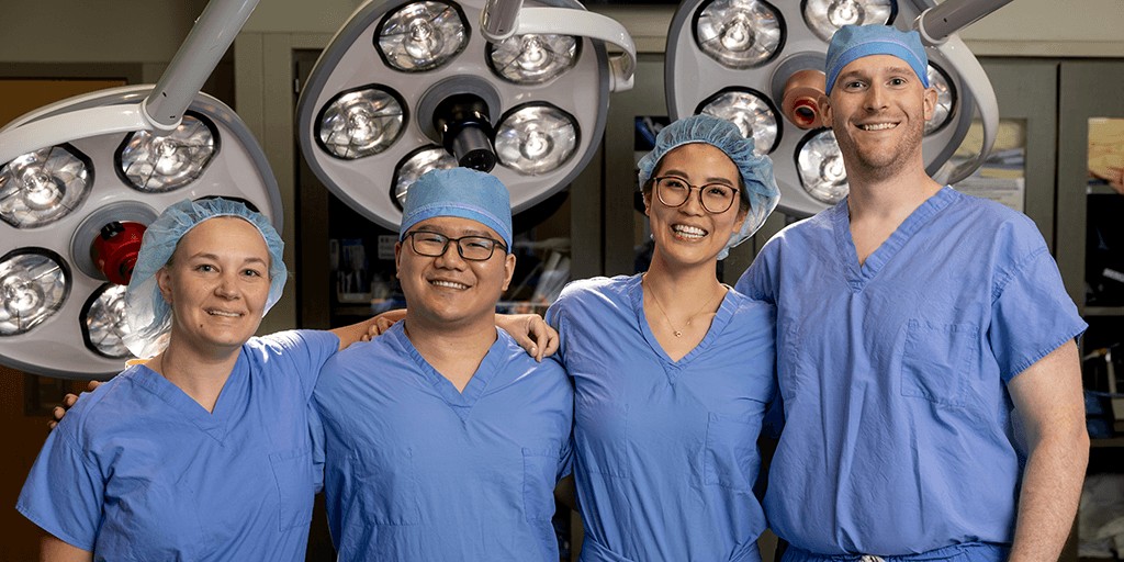 2025 residents pose for a group photo wearing scrubs