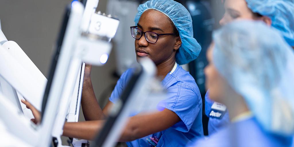 A doctor performs a practice procedure in an operating room.