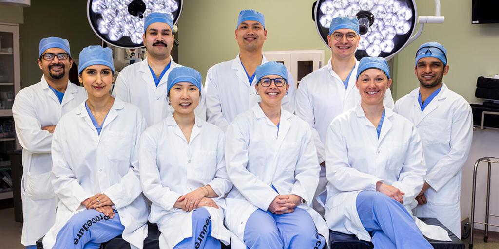 Group shot of general surgery residency program in Rochester, Minnesota, residents in an operating room.