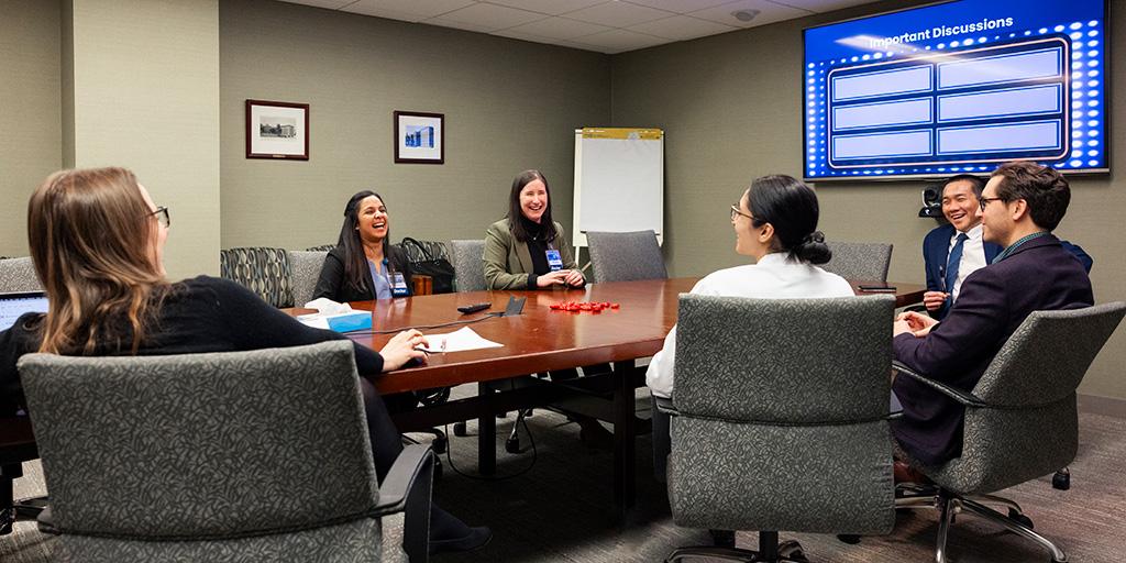 Attendees speak during the Gynecology Oncology Fellowship conference.
