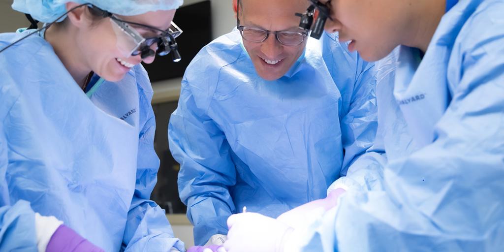 Three fellows in operating suite