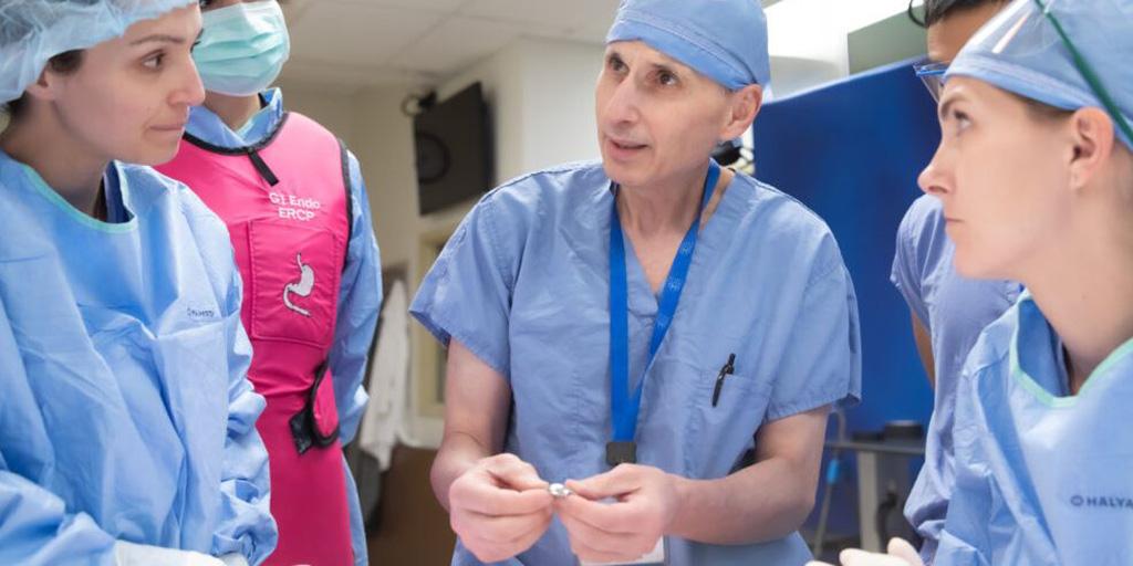 Dr. Rizzo teaching surgical skills in operating room.
