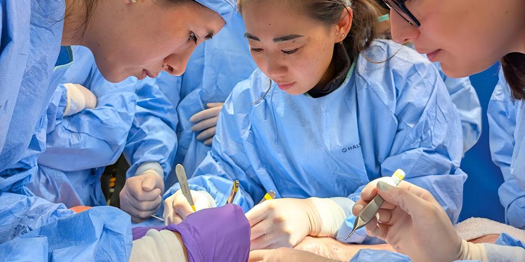 Three fellows performing surgery