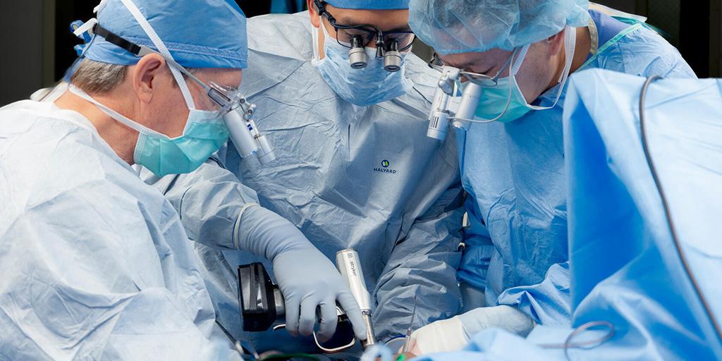 Three fellows in operating suite